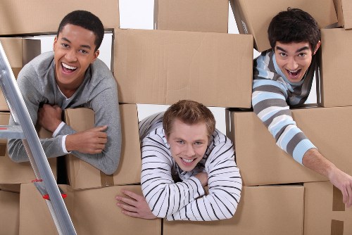 Commercial moving team handling office furniture and boxes in Hire