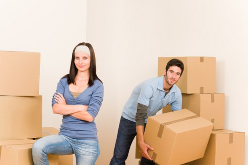 Packed office equipment and labelled moving crates for a business relocation
