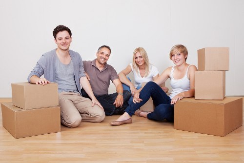 Moving boxes and furniture being loaded into a hire van